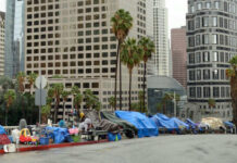 Street lined with tents and makeshift shelters downtown.
