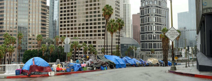 1469142698 Street lined with tents and makeshift shelters downtown.