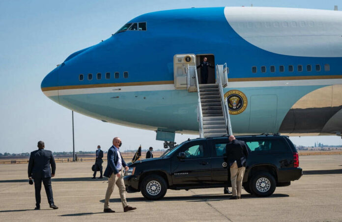 2047086128 Airplane with stairs and people on the tarmac