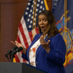 Newsmax Host Slams Michelle—What He Dug Up Person speaking with surprised expression at podium flags behind