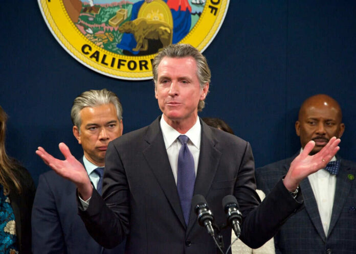 Man speaking at podium with people behind him