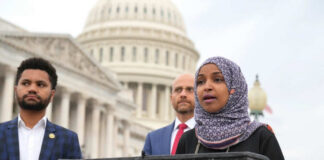 Three people speaking in front of US Capitol building