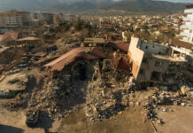 Cityscape with collapsed buildings and rubble after earthquake