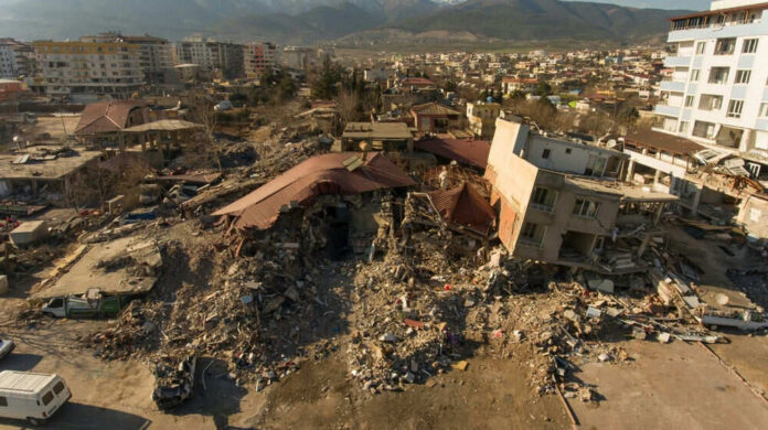 2310785455 Cityscape with collapsed buildings and rubble after earthquake