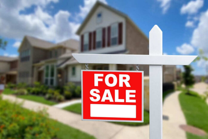 2328003657 For sale sign in front of house