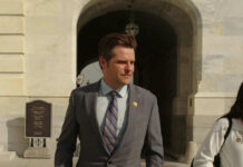 Power-and-Privilege Love Story Explodes Man in suit walking outside stone building