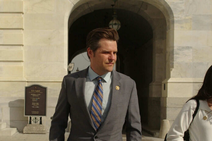Man in suit walking outside stone building