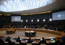 Conference room with large round table and attendees