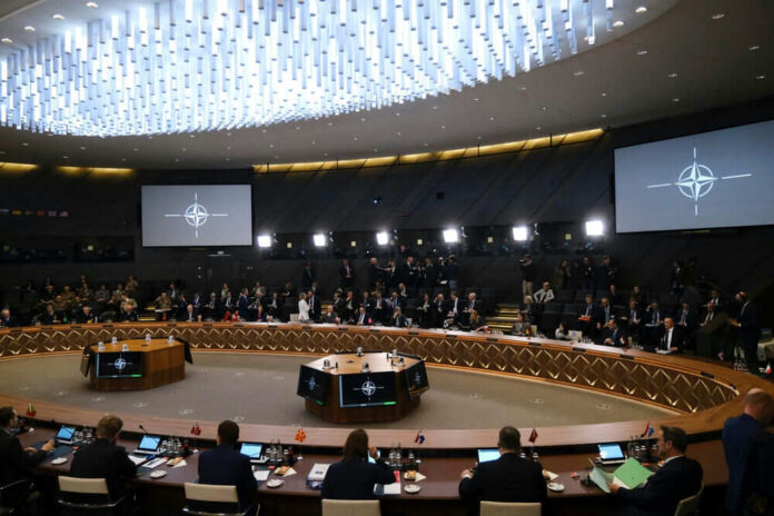 Conference room with large round table and attendees