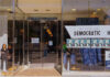 Storefront of Westside Democratic Headquarters with signs.