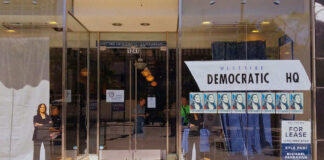 Storefront of Westside Democratic Headquarters with signs.