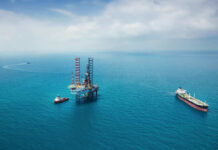 Trump Claims 65 Billion Barrels of Oil – Locked Oil rig surrounded by ships in the ocean.