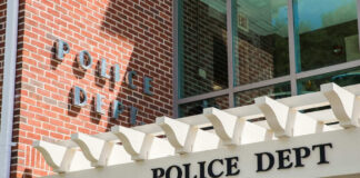Police department building with brick facade and signage.