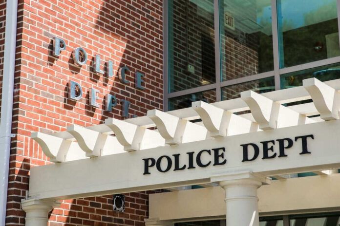 Police department building with brick facade and signage.