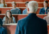Campus Scandal: Rutgers Dean Busted A speaker addressing an audience in a lecture hall