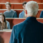 Campus Scandal: Rutgers Dean Busted A speaker addressing an audience in a lecture hall