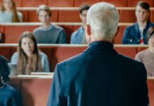 Campus Scandal: Rutgers Dean Busted A speaker addressing an audience in a lecture hall