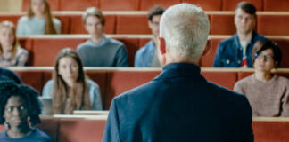A speaker addressing an audience in a lecture hall