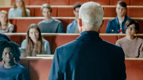 A speaker addressing an audience in a lecture hall