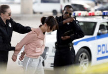 Police officers arresting a suspect in an urban environment