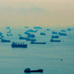 Pirates Hijack Tanker — Ransom Numerous cargo ships scattered across a hazy ocean