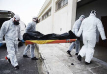 Horror Inside Chicago Funeral Home Emergency responders in hazmat suits carrying a body on a stretcher