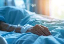 Hero Dad’s Split-Second Dive, Unthinkable Aftermath A patient's hand resting on a hospital bed with an IV line attached