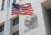 American flag waving in front of a United States court house