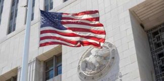 American flag waving in front of a United States court house