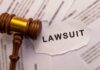 Trump Hating Judge Gets What She Deserves A wooden gavel next to a torn paper with the word 'LAWSUIT'