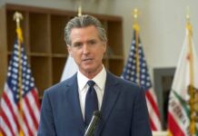 Ethics Bombshell Rocks California GOP A government official speaking at a podium with flags in the background