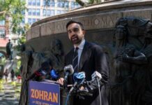Crowd Erupts—Mamdani Gets Booed And Runs A man giving a speech at a podium in a city park