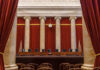 Probation After Baby’s Death Sparks Fury Interior view of a courtroom with red curtains and marble columns