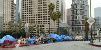Street lined with tents and makeshift shelters downtown.