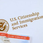 U.S. Citizenship and Immigration Services logo with document.