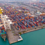 Aerial view of a busy shipping container port.