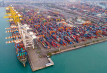 Beijing’s Timed Move Before Trump Aerial view of a busy shipping container port.