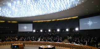Conference room with large round table and attendees