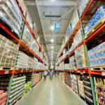 Warehouse aisle filled with stacked products on shelves
