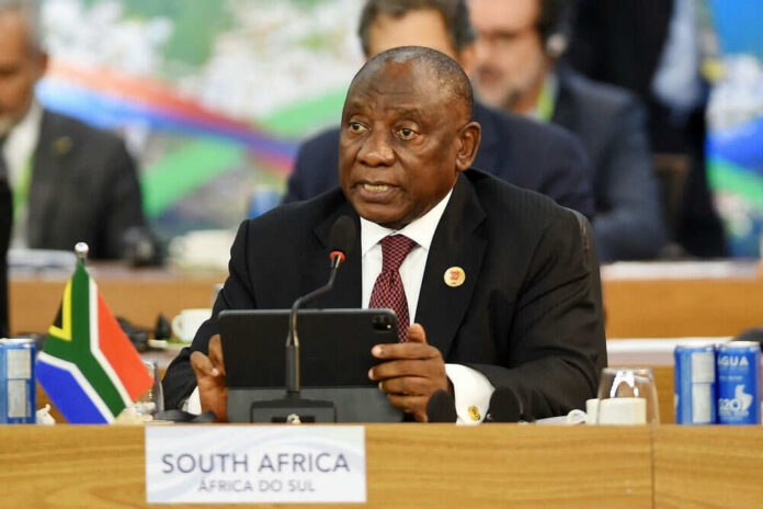 2567468309 Man speaking at conference with South African flag