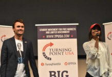 Two speakers at a Turning Point USA event addressing the audience