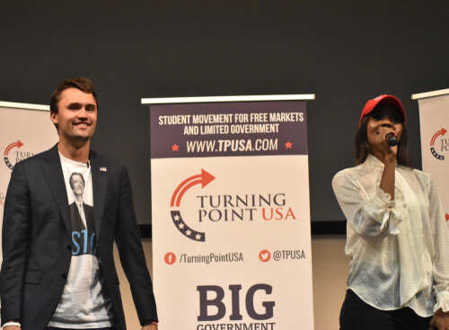 Two speakers at a Turning Point USA event addressing the audience