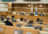 Audience attending a government meeting in a conference room