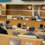Audience attending a government meeting in a conference room