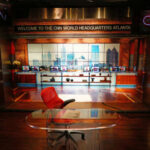 Interior of CNN World Headquarters studio with a red chair and glass desk