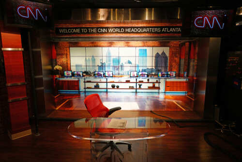 Interior of CNN World Headquarters studio with a red chair and glass desk
