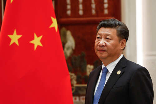 Hangzhou,/,China,09/05/2016,President,Of,The,People's,Republic,Of A political leader standing beside the Chinese national flag