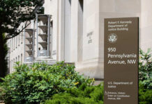 Exterior view of the Robert F. Kennedy Department of Justice Building with a sign