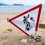 Warning sign about jellyfish hazards on a beach