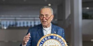 A government official speaking at a podium with the United States Senate seal